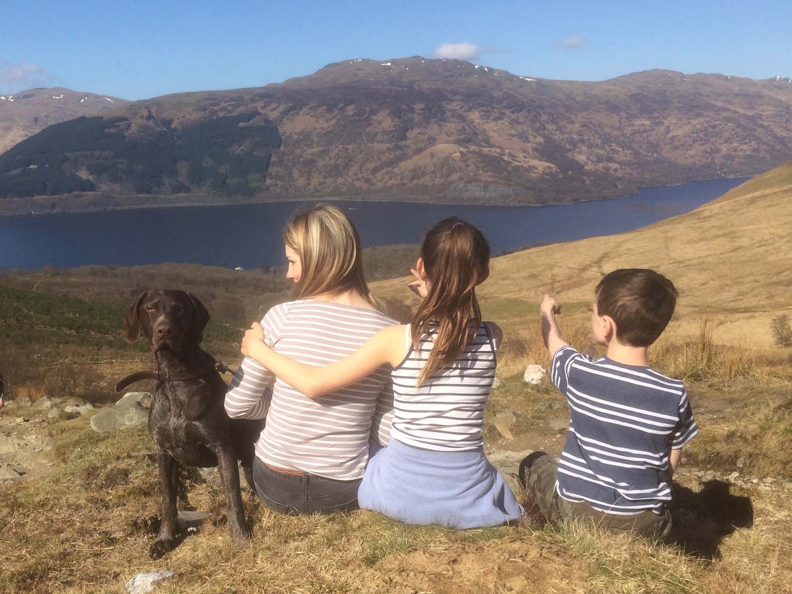Linda Macdonald and family overlooking a Scottish Loch